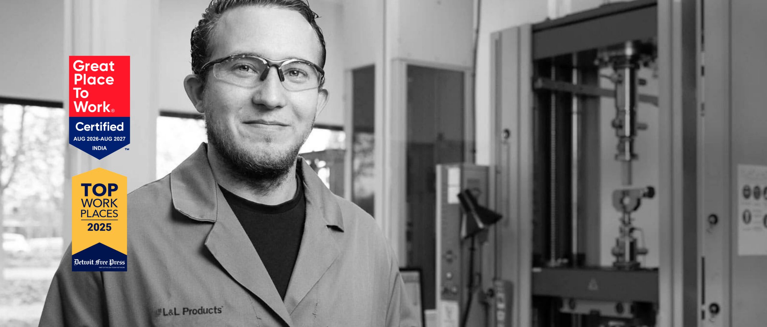 An L&L Products employee wearing a lab coat and smiling