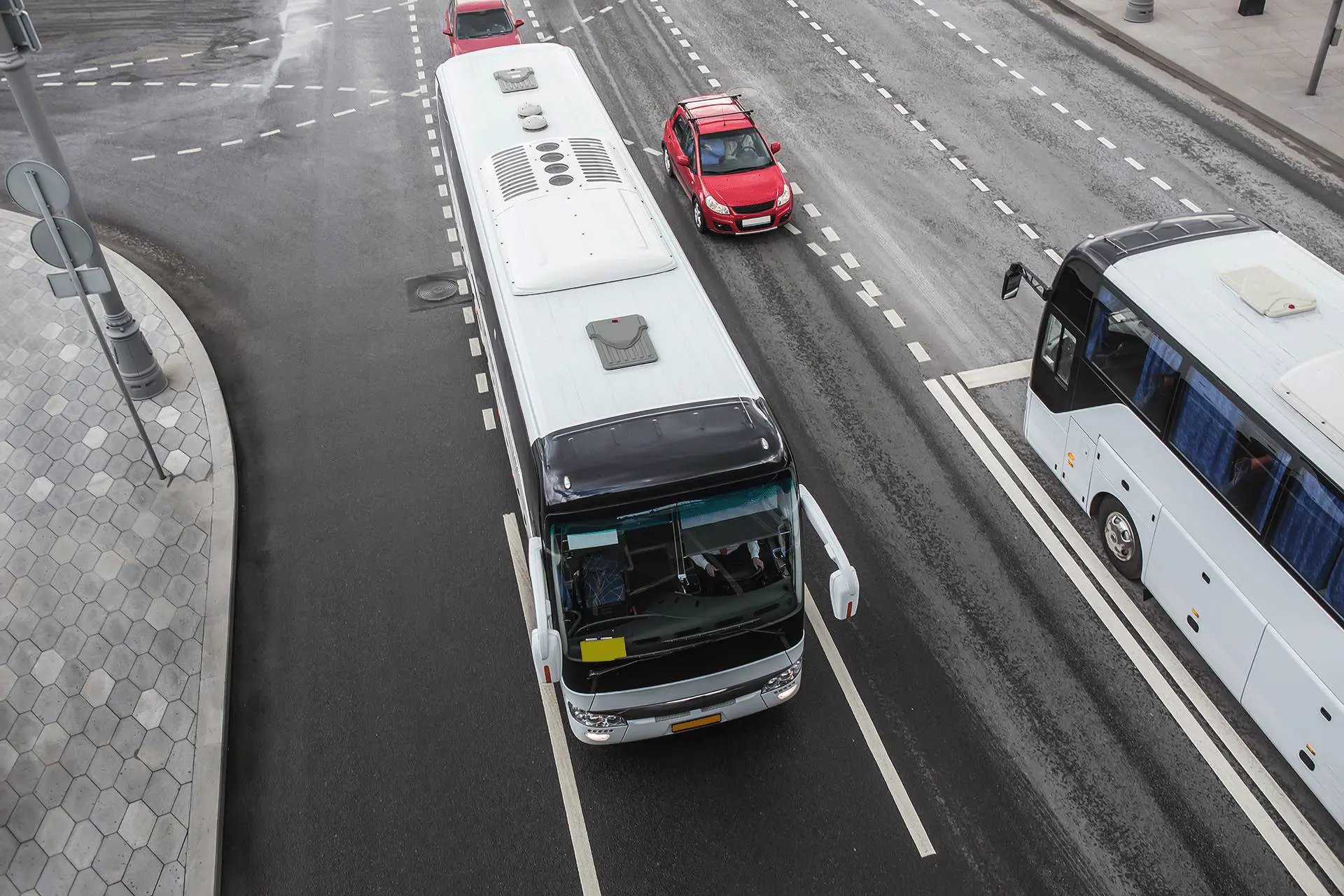 Tourist Buses traveling in the opposite direction on the city Avenue. The view from the top.