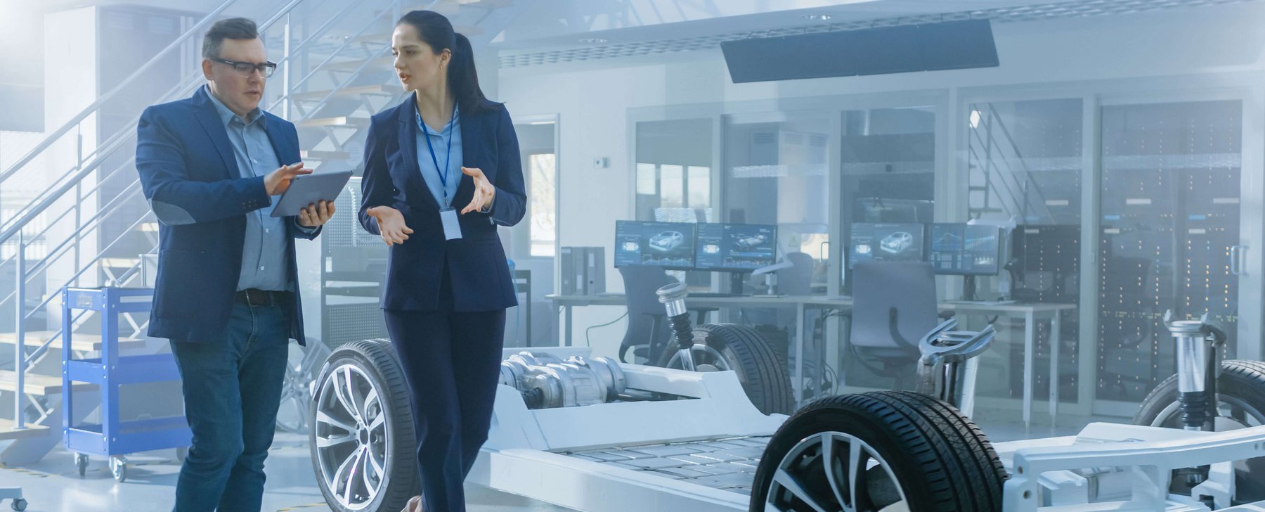 Two people walking in a R&D Lab