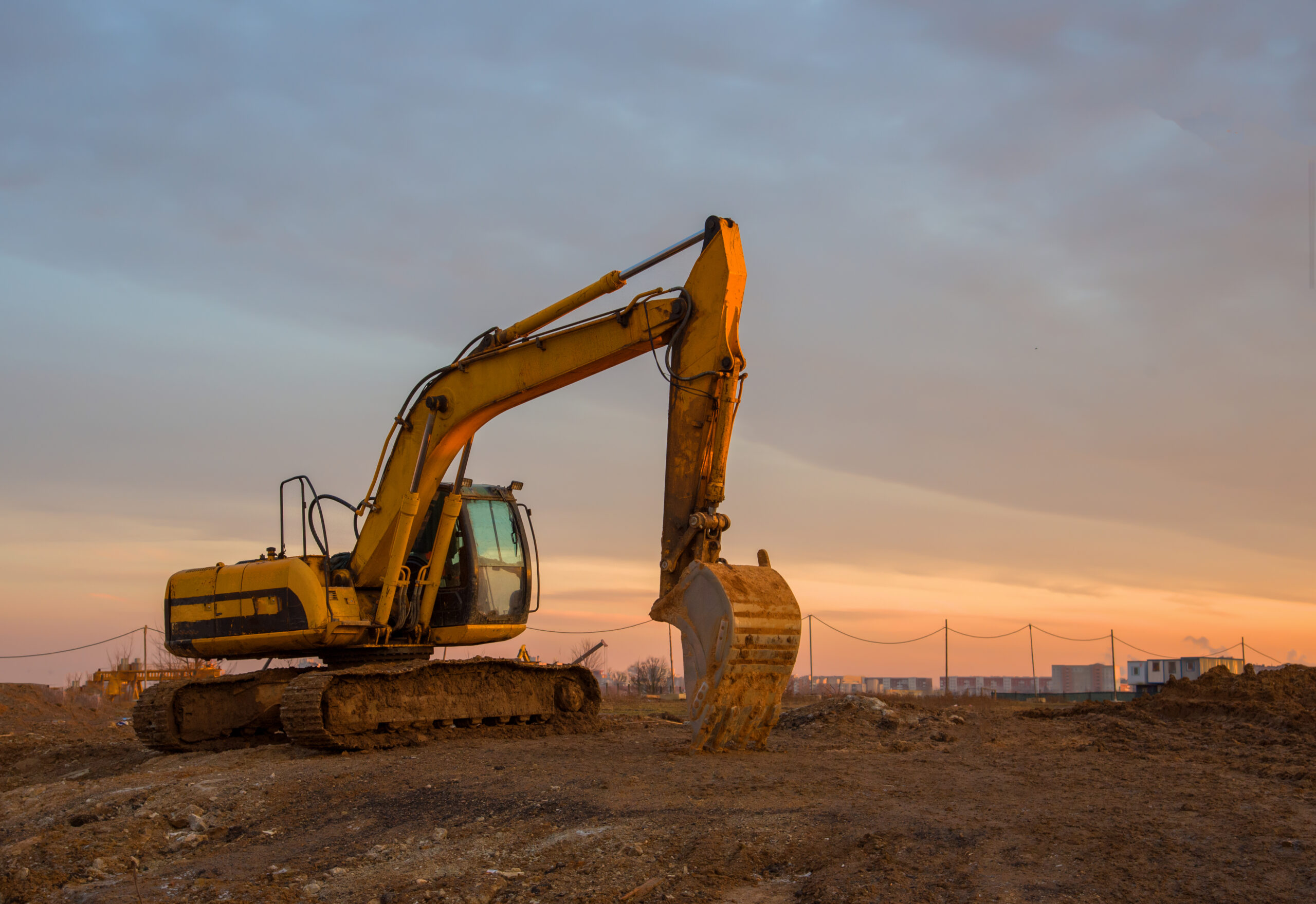 Excavator,On,Earthworks,At,Construction,Site,On,Sunset,Background.,Backhoe A woman pumping gas